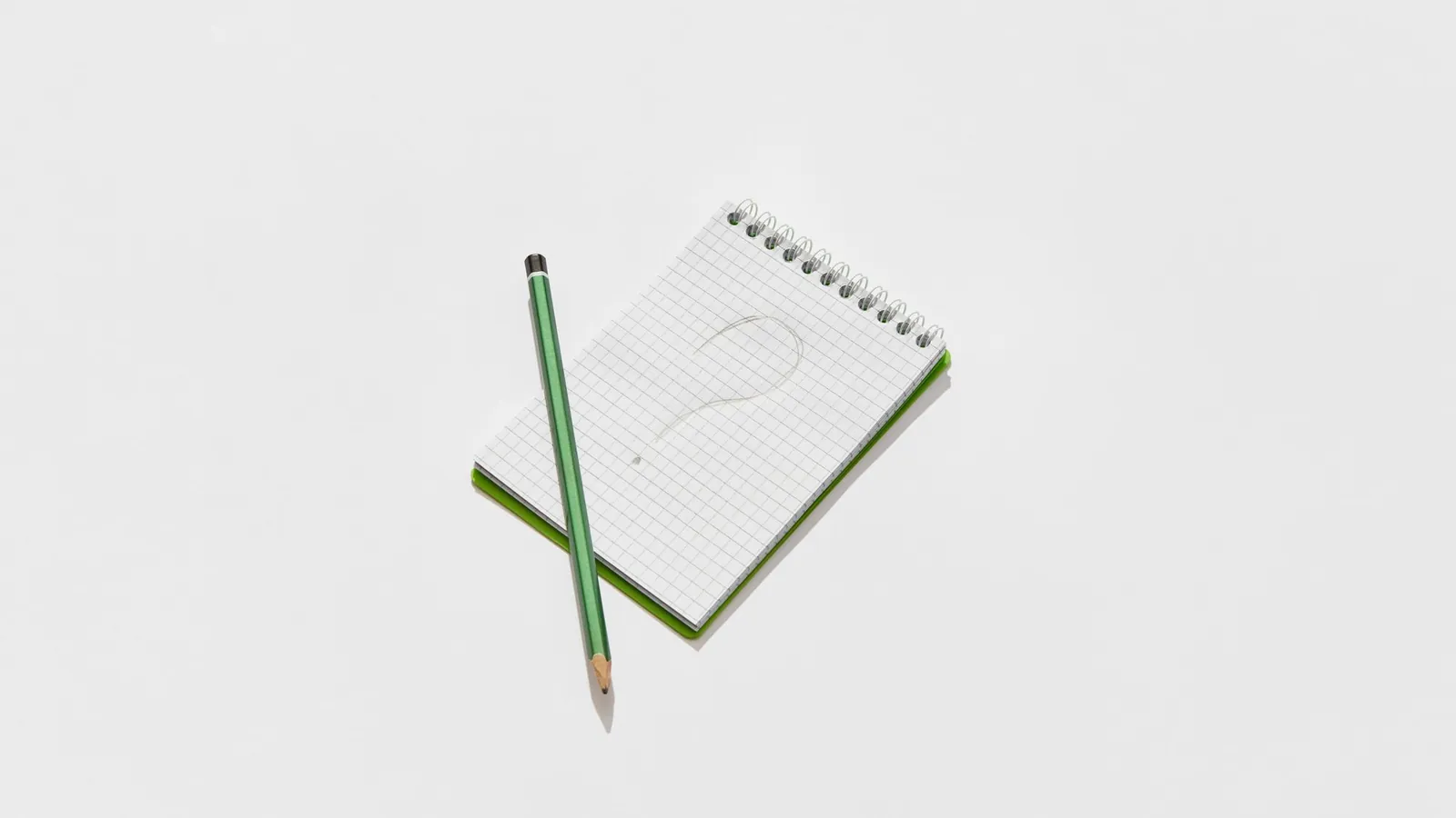 Notepad with a question mark, representing the questions answer engine optimization content should answer